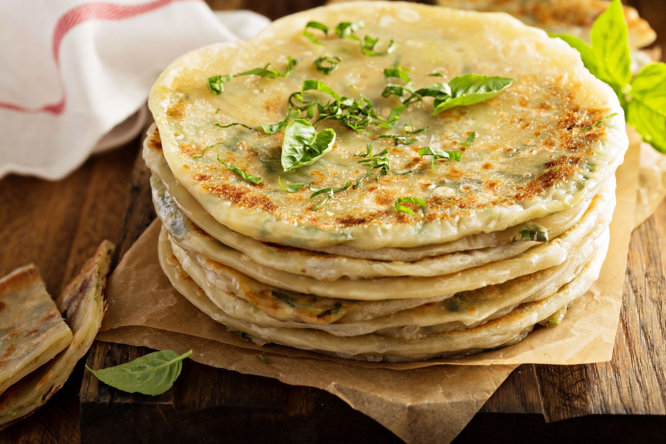 Stack of savory Asian scallion pancakes, a popular warm breakfast dish