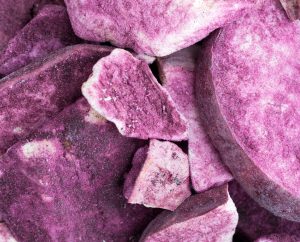 Close-up of fresh purple ube (Filipino purple yam) showcasing its vibrant violet flesh and natural texture.